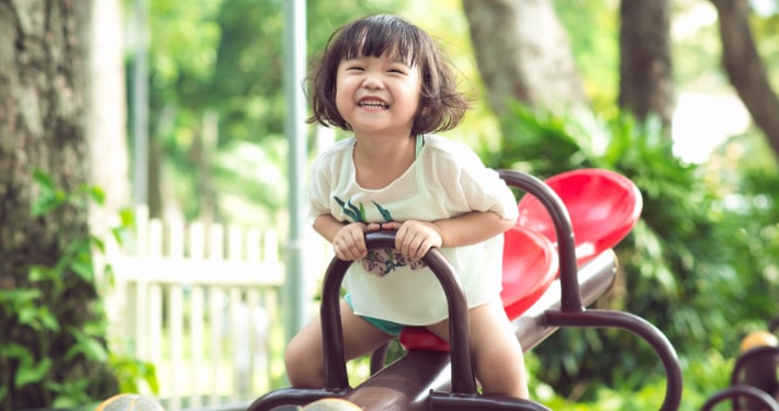 A smiling Asian girl on the playground