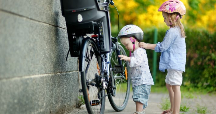Two sisters wearing bike helmets